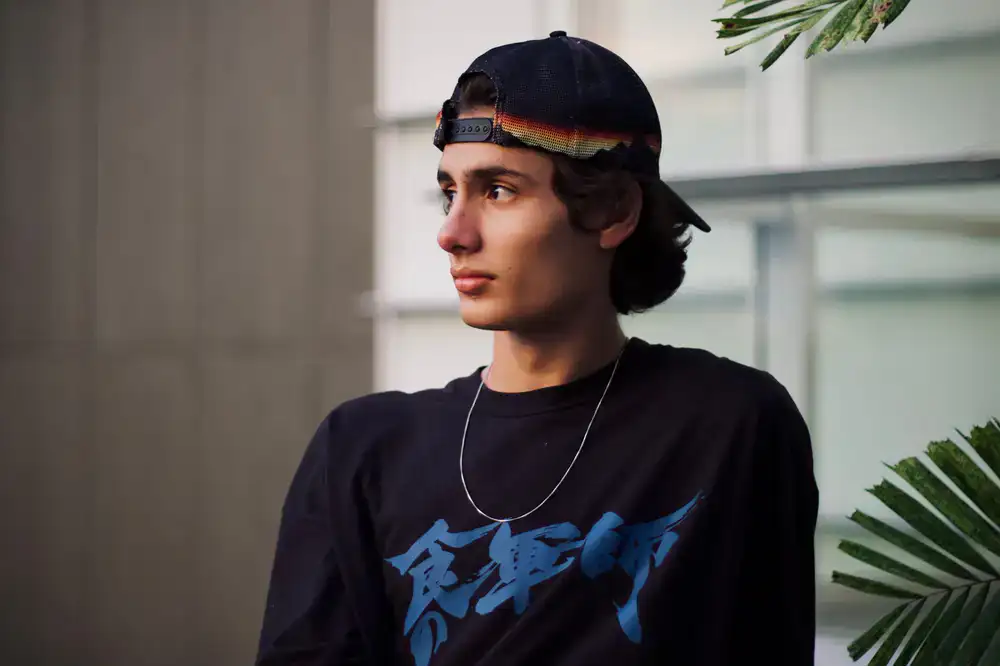 Black streetwear snapback cap with neon green embroidered logo