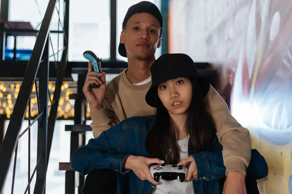 Gamers wearing bold streetwear sitting with controllers