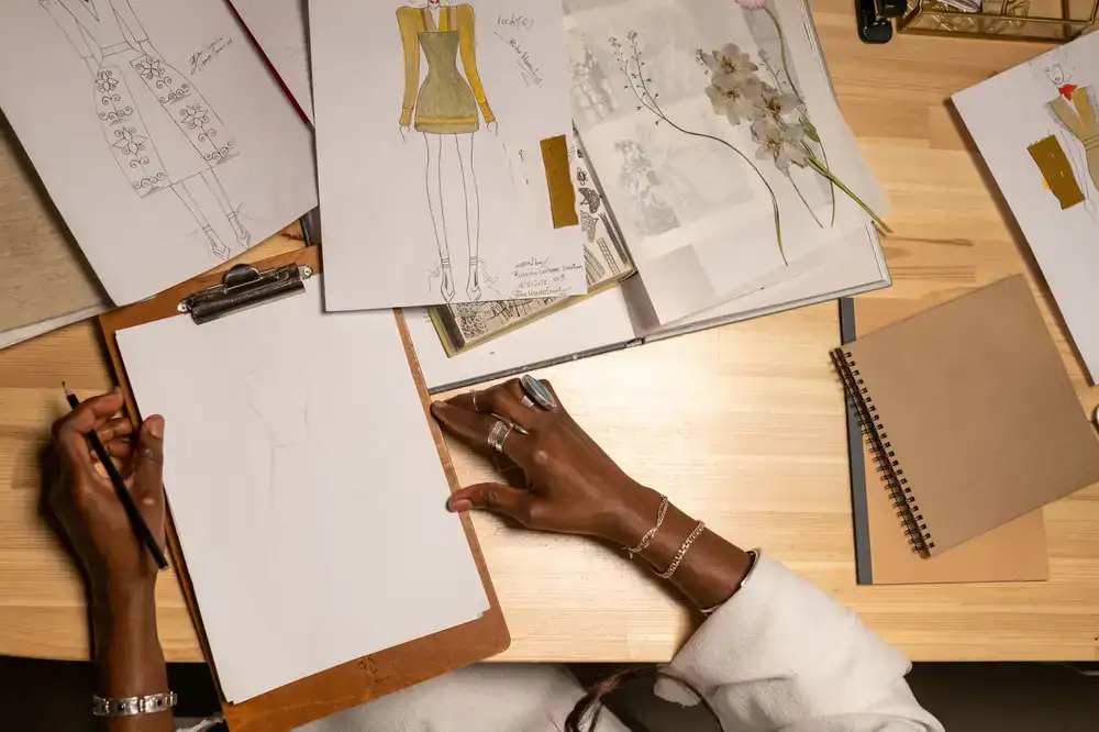 Designer sketching streetwear concepts in a dark studio